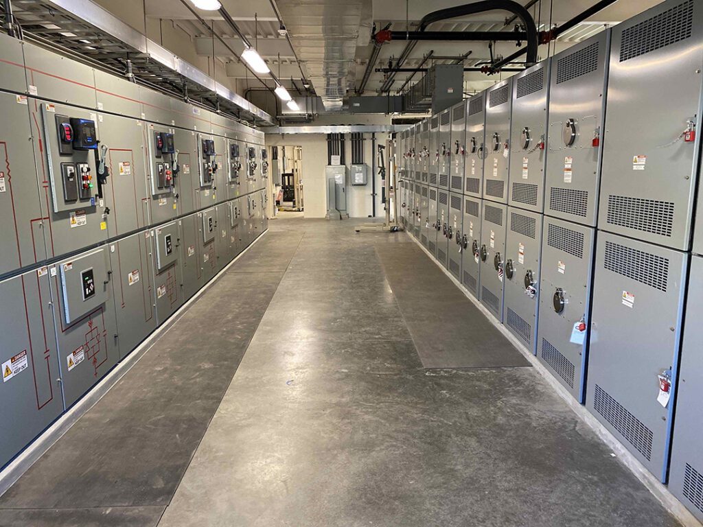 A long hallway of electrical equipment in the Union Hills water treatment plant building.